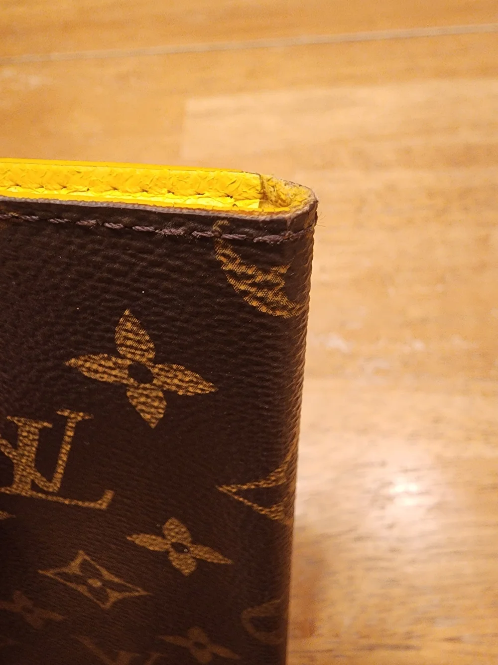 Louis Vuitton Monogram iPhone Folio Case crafted in the brand's signature brown